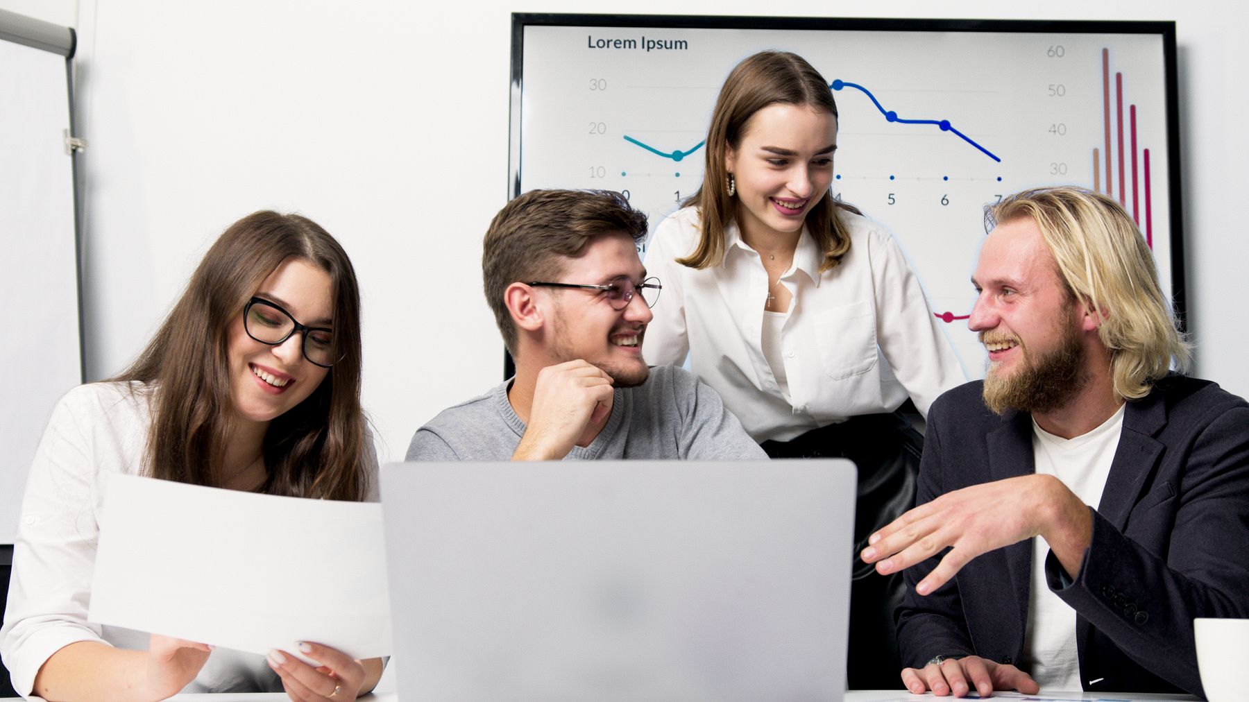 Colleagues collaborating around a laptop